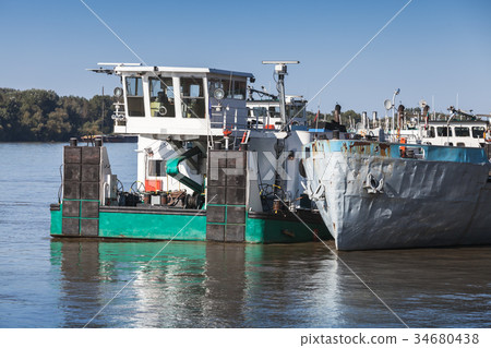 Pusher boat stands moored on Danube river 34680438