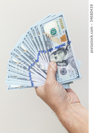 Vertical photo. Fan of One Hundred Dollars notes 34680439