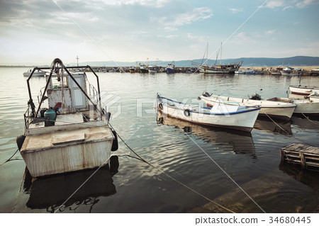 Small fishing boats are moored in port Small fishing boats are moored in port 34680445