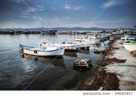 White wooden fishing boats are moored White wooden fishing boats are moored 34680447