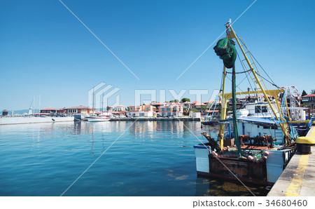 Fishing boat stands moored in port Fishing boat stands moored in port 34680460