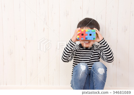 Boy holding a block 34681089
