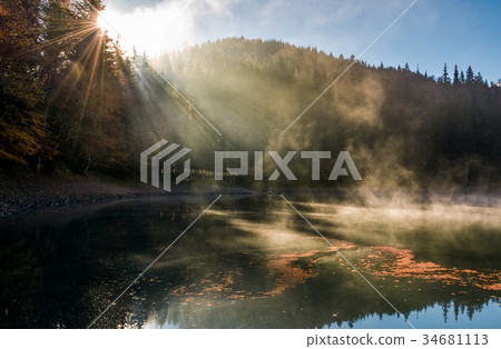 sun light in fog over the mountain lake Synevyr sun light in fog over the mountain lake Synevyr 34681113