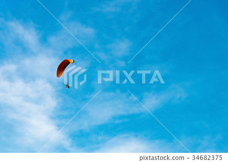 man ride Paramotor flying in the sky 34682375
