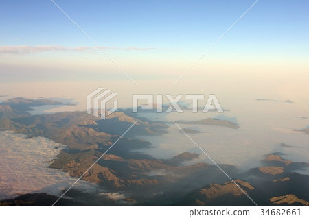 Aerial view of the Andes Mountains floating in the sea of spring and morning cloud in central South America Chile 34682661