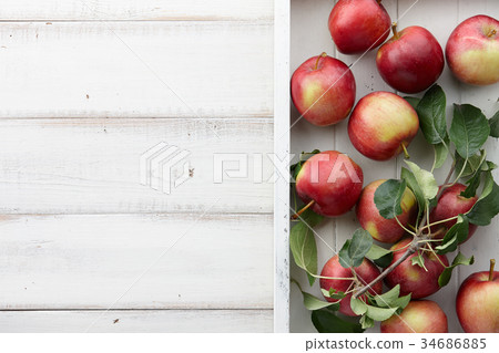 White wooden tray with fresh apples, autumn harvest White wooden tray with fresh apples, autumn harvest 34686885