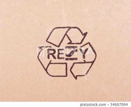 torn out piece of cardboard with recycle symbol 34687004