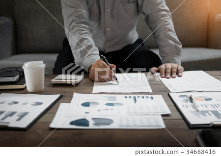 Business man analysed report of profit finance data graph docume Business man analysed report of profit finance data graph docume 34688416