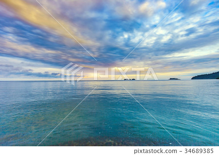 Beautiful sunrise at the shore with cloudy sky 34689385