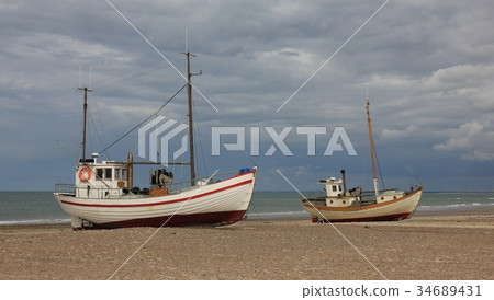 Two fishing boats on a cloudy summer day. 34689431