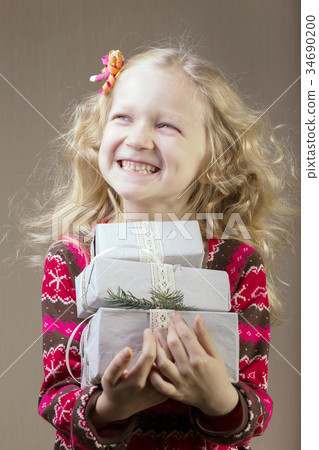 girl holding presents in hands girl holding presents in hands 34690200