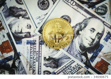 Gold coin bitcoin on hundred dollar bills Gold coin bitcoin on hundred dollar bills 34690675