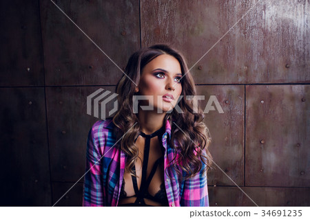 pretty girl sits on the bathtub in a shirt 34691235