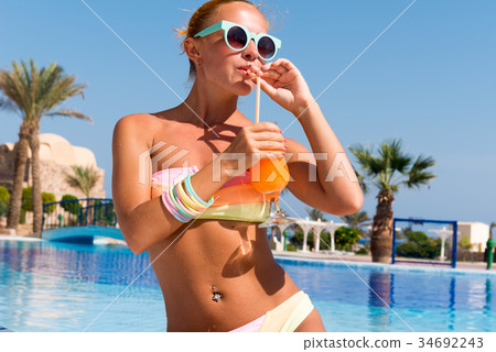 Happy young woman with cocktail Happy young woman with cocktail 34692243