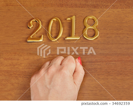 Hand and numbers 2018 on door - newyear background Hand and numbers 2018 on door - newyear background 34692359