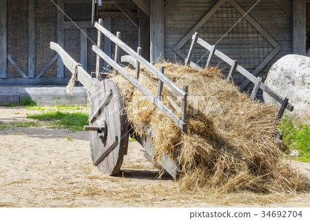 Old wooden wagon with straw Old wooden wagon with straw 34692704