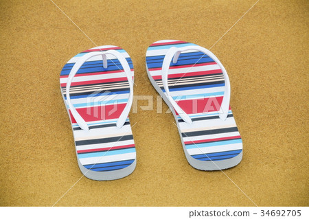 Flip flops on the sandy beach Flip flops on the sandy beach 34692705