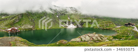 Panorama of a mountain lake. Typical alpine house Panorama of a mountain lake. Typical alpine house 34693075
