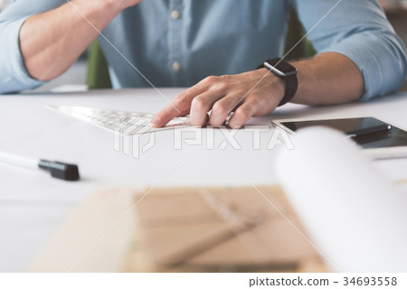 Youthful architect is using professional tool 34693558