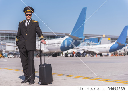 Assured male aviator locating on runway 34694289