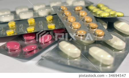 a set of various tablets and capsules in blisters 34694547