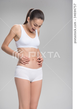 Cheerful fit girl is satisfied with her body Cheerful fit girl is satisfied with her body 34694757