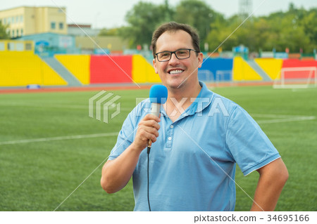 Middle age man TV reporter is broadcasting Middle age man TV reporter is broadcasting 34695166