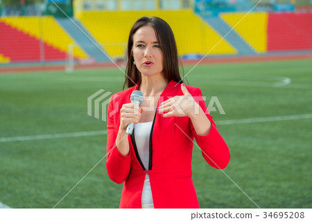 Young girl TV reporter is broadcasting 34695208