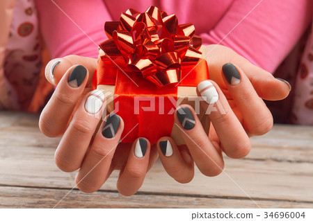 Handmade gift box in female hands. 34696004