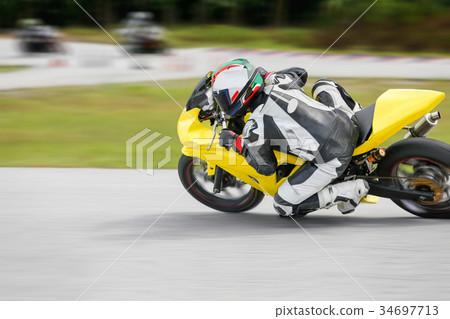Motorcycle leaning into a fast corner on track 34697713