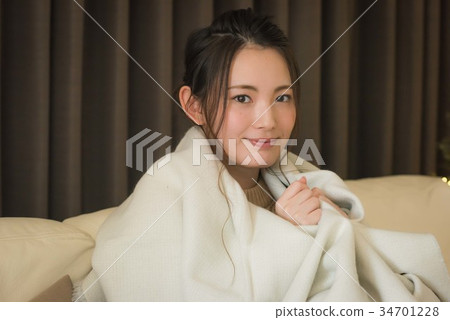Young woman wrapped in a blanket Young woman wrapped in a blanket 34701228