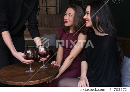Flirty mood in bar. Playful females company Flirty mood in bar. Playful females company 34703372