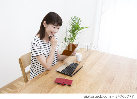 Young woman checking home work schedule 34703777