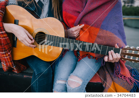 Playing guitar and meeting on roof, close up Playing guitar and meeting on roof, close up 34704483