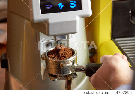 Coffee machine and male hand. Coffee machine and male hand. 34707896