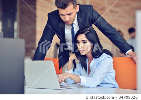 business couple in an office working on the business couple in an office working on the 34709320