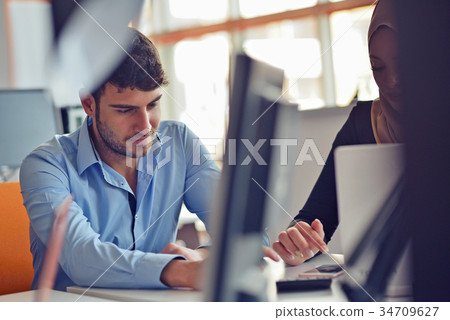 Freelance programmer working in startup office Freelance programmer working in startup office 34709627