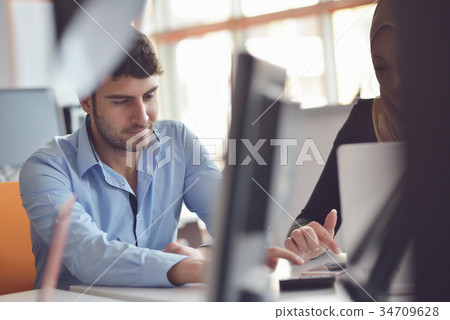 Freelance programmer working in startup office Freelance programmer working in startup office 34709628