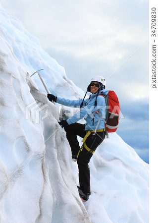 The girl climbing on the glacier The girl climbing on the glacier 34709830