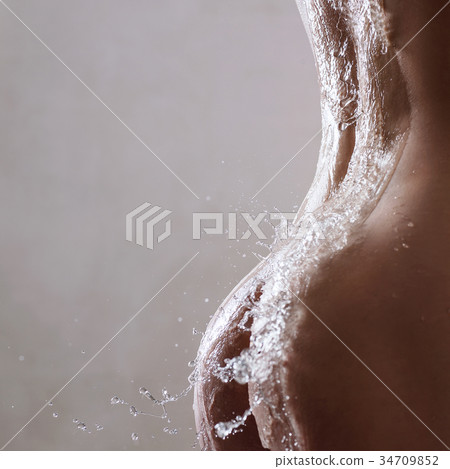 Sexy woman back in splashes of water. 34709852