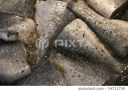 Fish frying in a frying pan 34711736