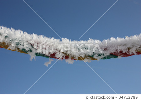 snowflakes against the sky on a rope. snowflakes against the sky on a rope. 34712789