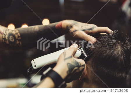 Barber shaving man in chair 34713608