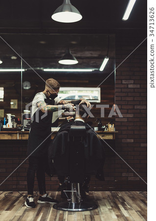 Stylish man working with client in salon Stylish man working with client in salon 34713626
