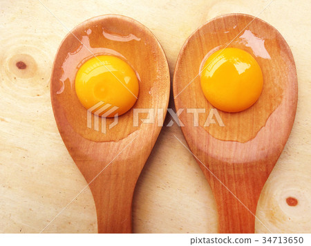 York eggs on wooden ladle on wooden background 34713650