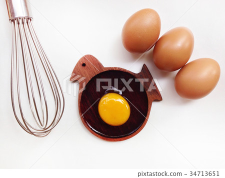 Egg yolk on wooden bird shaped saucer 34713651