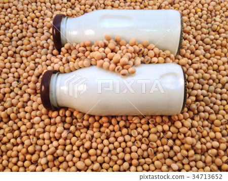 Soy milk in bottle on soy beans background Soy milk in bottle on soy beans background 34713652