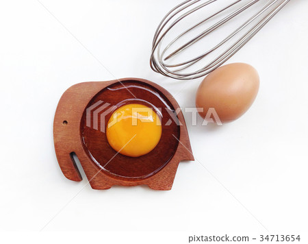 Egg yolk on wooden elephant shaped saucer Egg yolk on wooden elephant shaped saucer 34713654