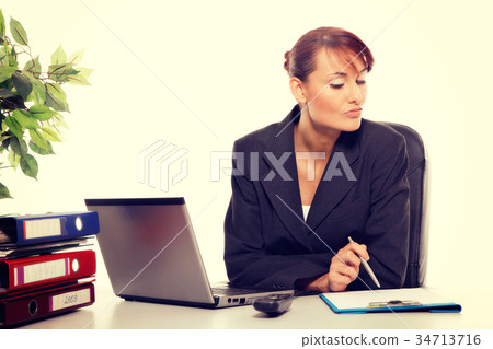 Young attractive business woman using laptop 34713716