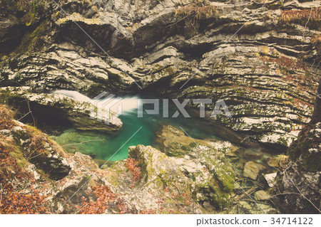 Rocks eroded by water from stream in autumn forest Rocks eroded by water from stream in autumn forest 34714122